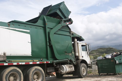 Low-emission van loading recycled materials at a transfer station
